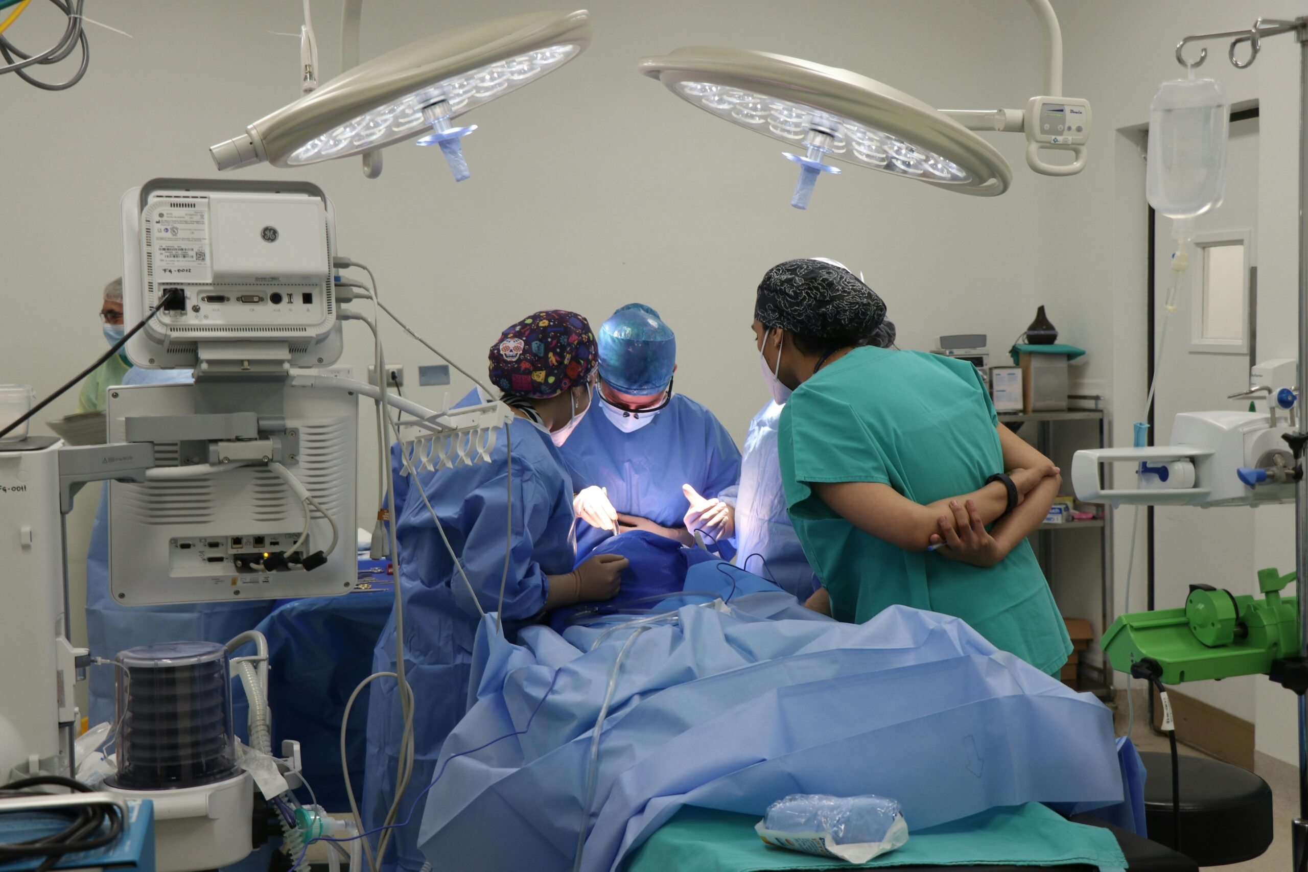 Team of surgeons operating in a well-equipped surgical room.